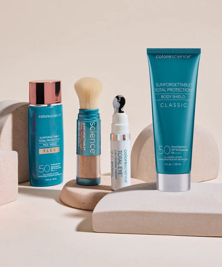 Collection of Colorescience sun protection products: face shield, body shield, brush-on mineral powder, and eye cream