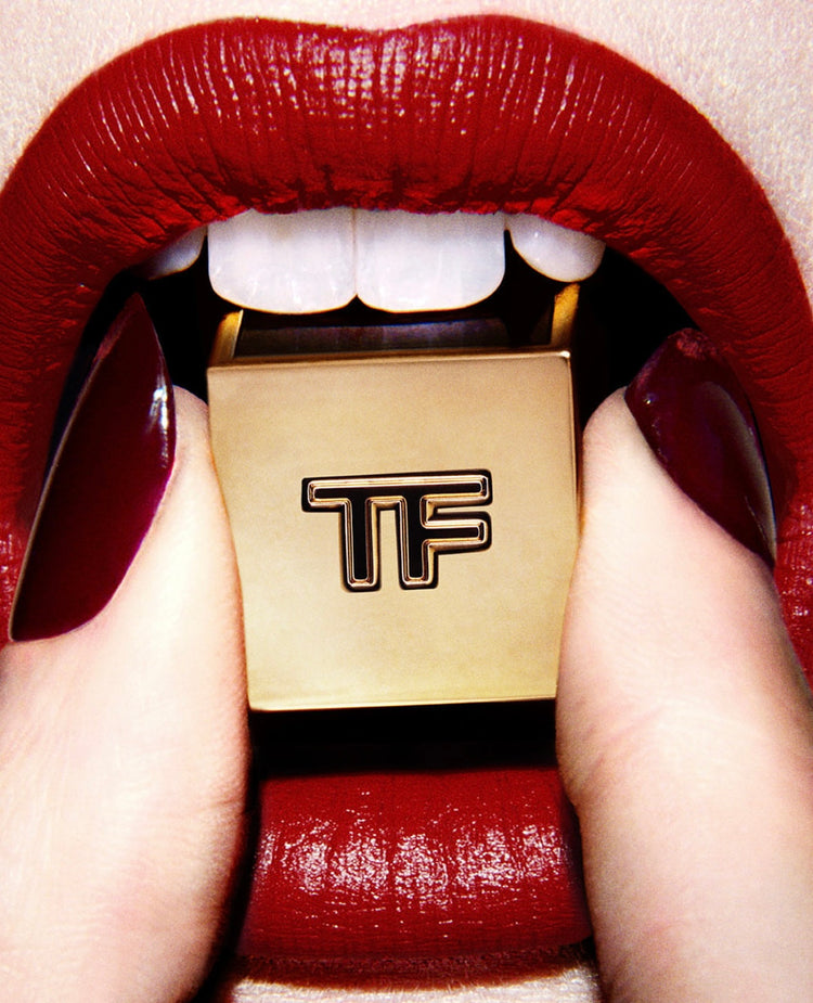 Tom Ford makeup close-up of red lips and polished nails.