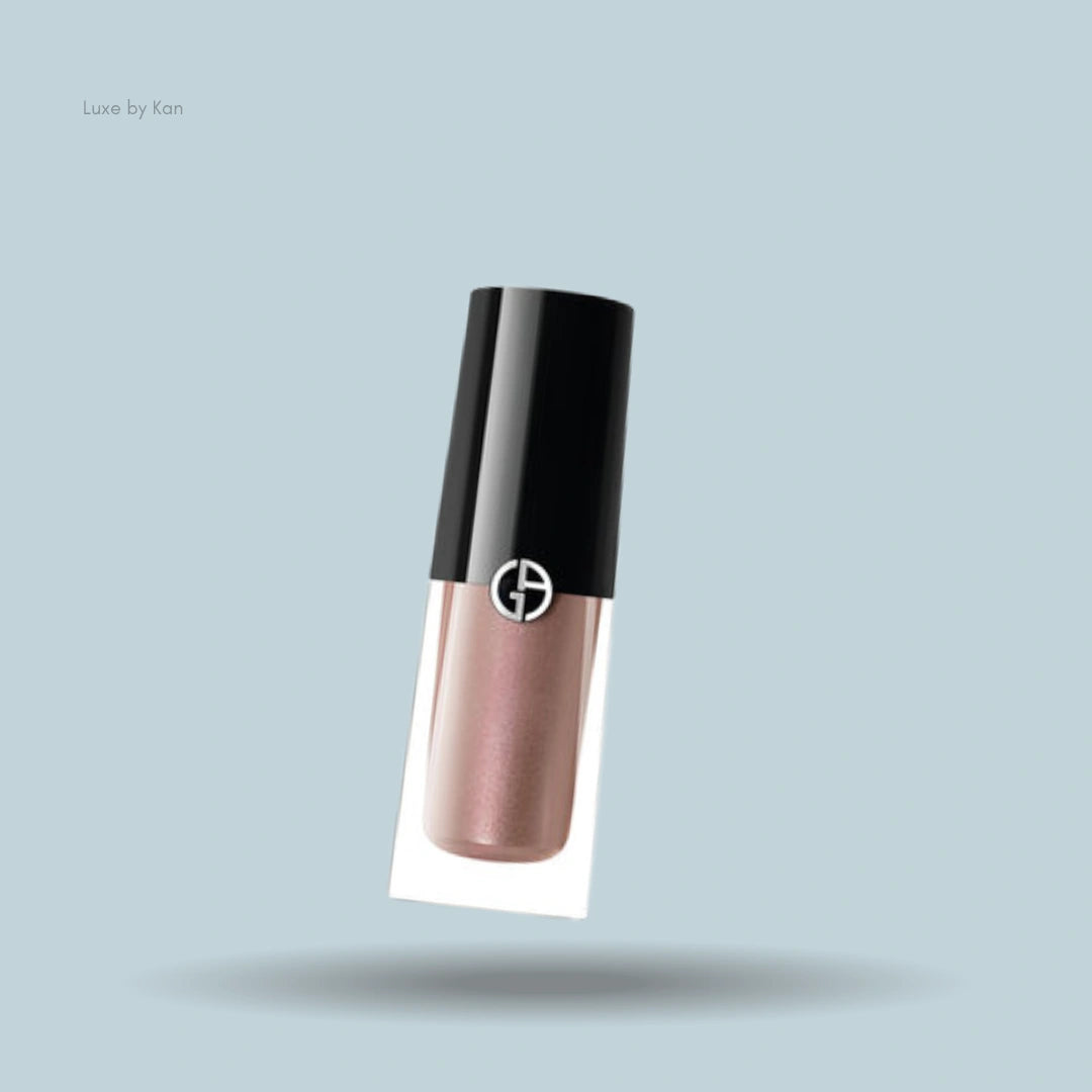 Armani liquid eyeshadow in caramel tint, black cap with logo.