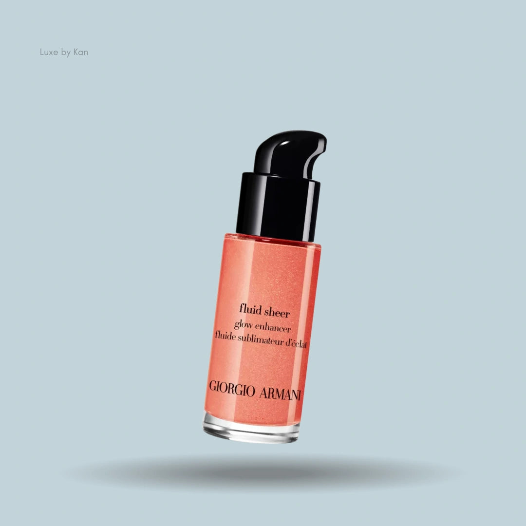 Close-up of Giorgio Armani Fluid Sheer glow enhancer in a coral shade, featuring black pump, clear bottle with text.