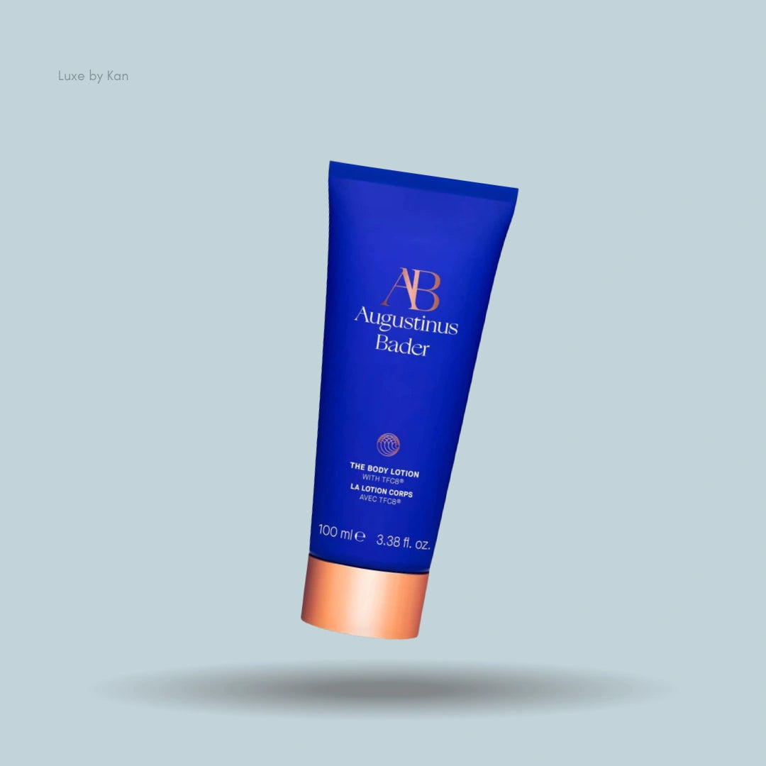 Augustinus Bader body lotion tube in signature blue with a copper-colored cap.