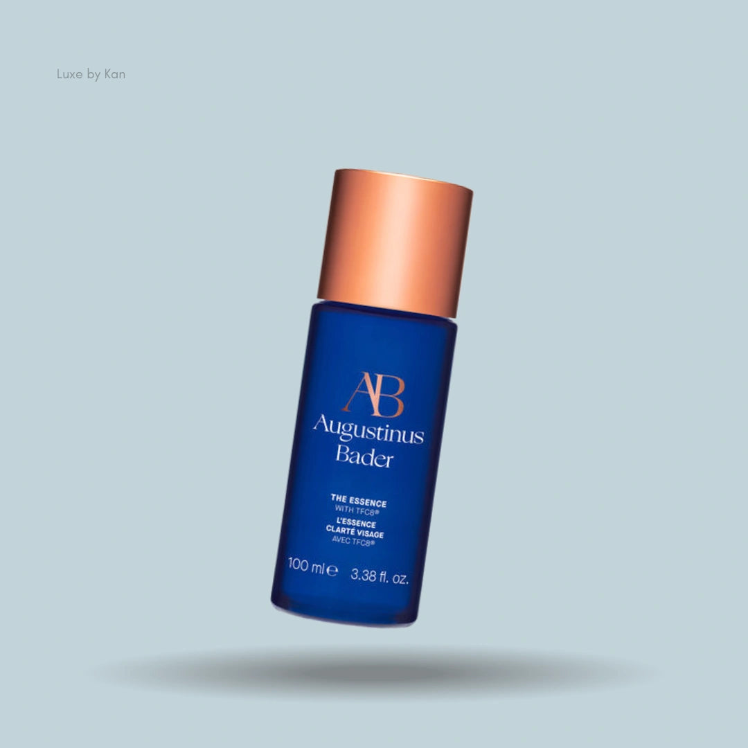 Augustinus Bader's The Essence in a royal blue bottle with a rose gold cap.