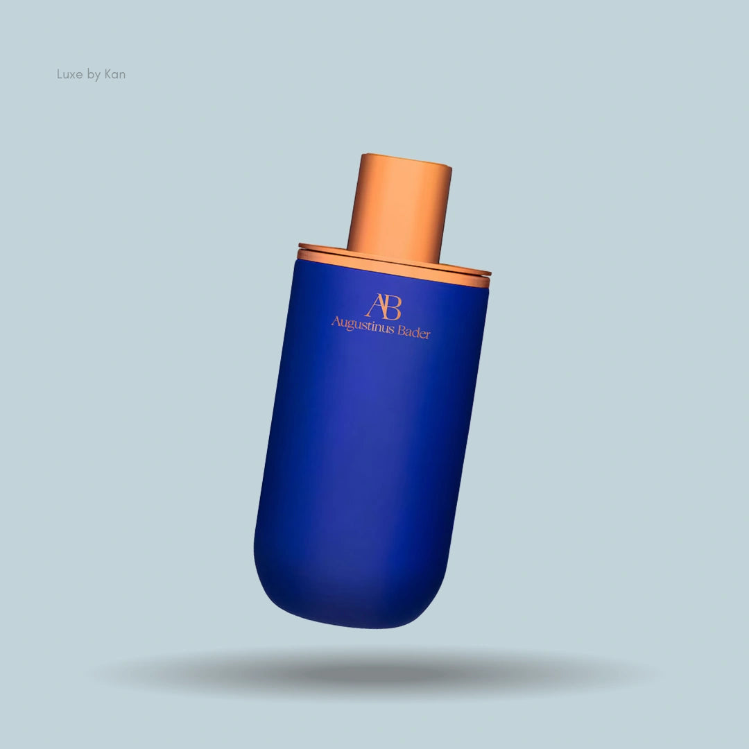 Augustinus Bader eye cream featuring a navy blue container with copper accents and lid.