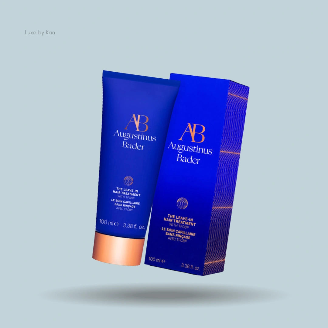 Augustinus Bader leave-in hair treatment tube and corresponding packaging in blue, with copper accents.