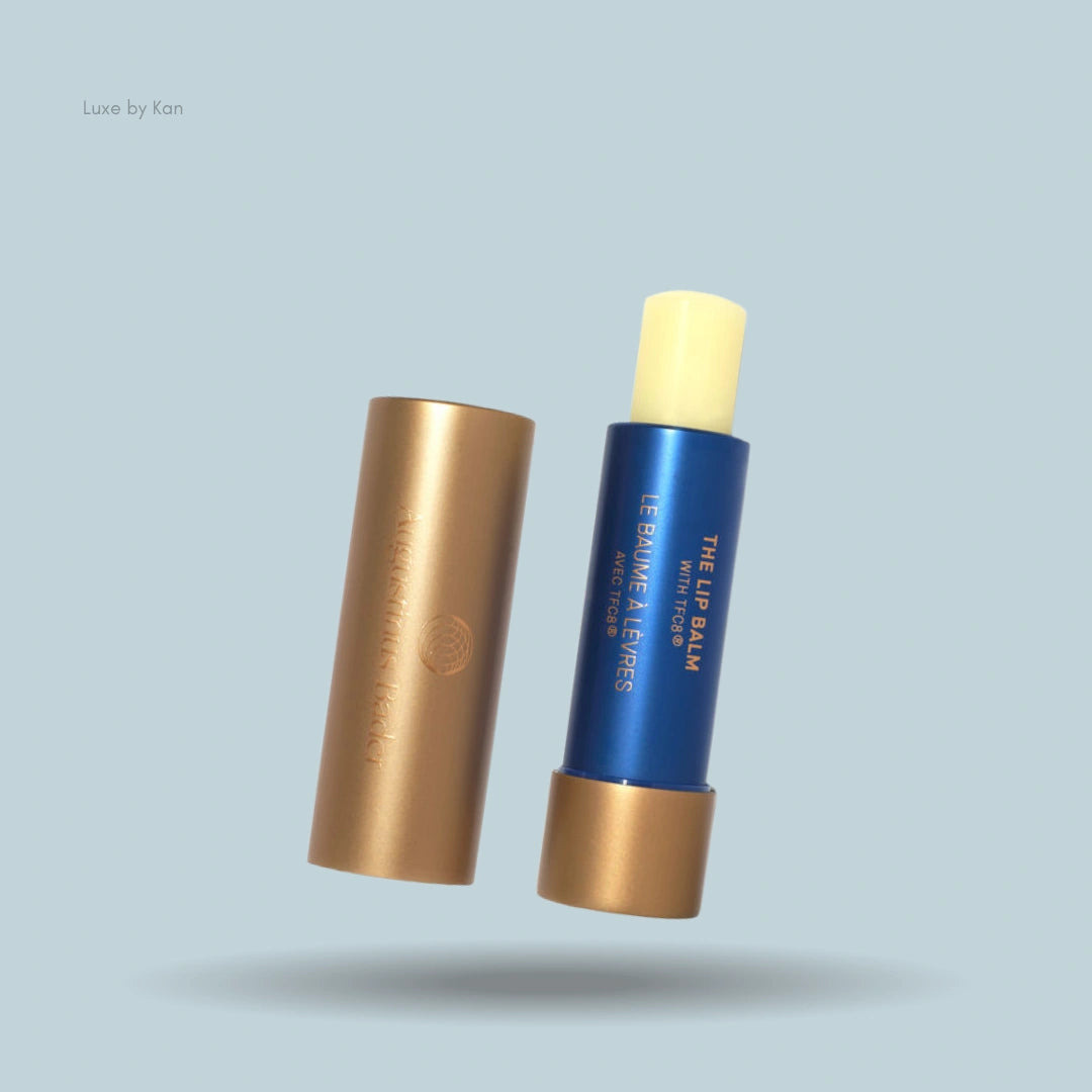 Augustinus Bader Lip Balm with the cap removed and placed beside the tube.