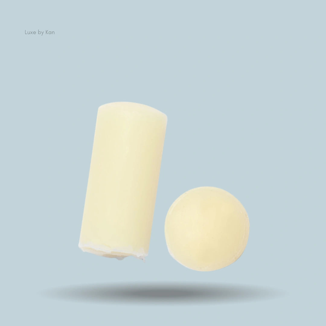 Close-up of Augustinus Bader The Lip Balm cylinder and ball.