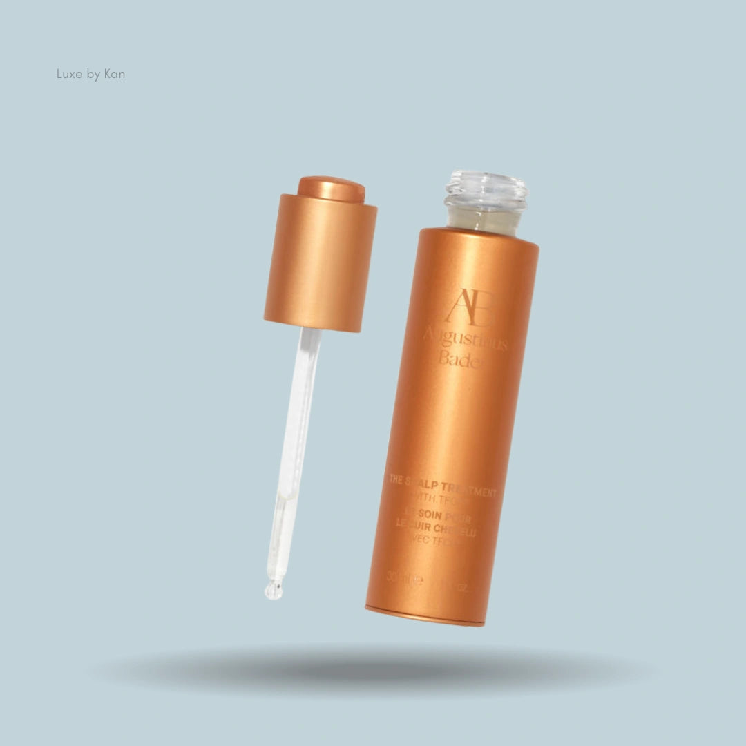 Augustinus Bader The Scalp Treatment bottle with applicator, featuring the product name and description on the container.