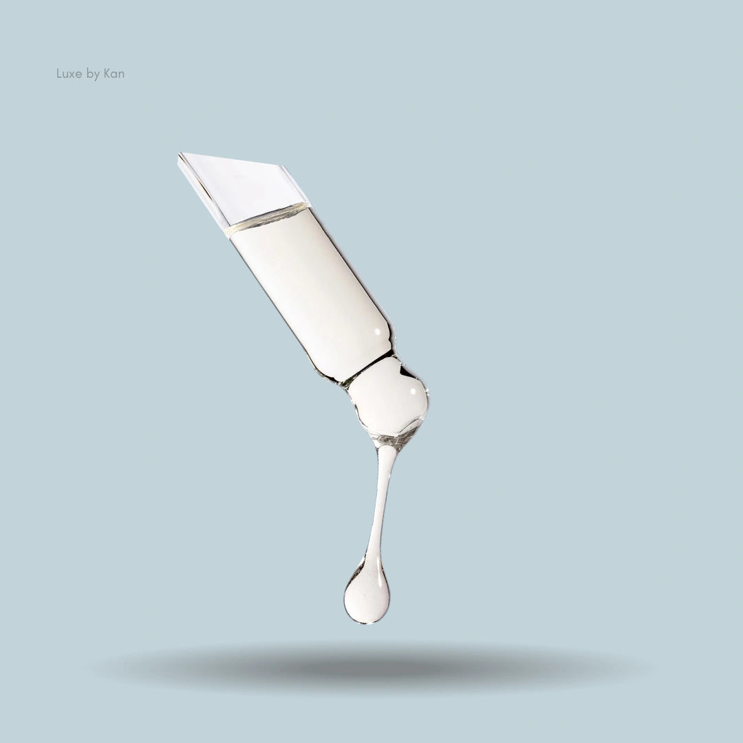 Dropper with Augustinus Bader's clear scalp treatment liquid dripping.