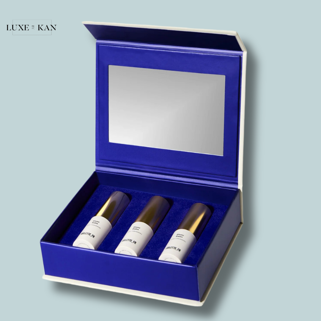 A luxurious blue gift box containing trio elegant bisou balm avec amour edition lipsticks.