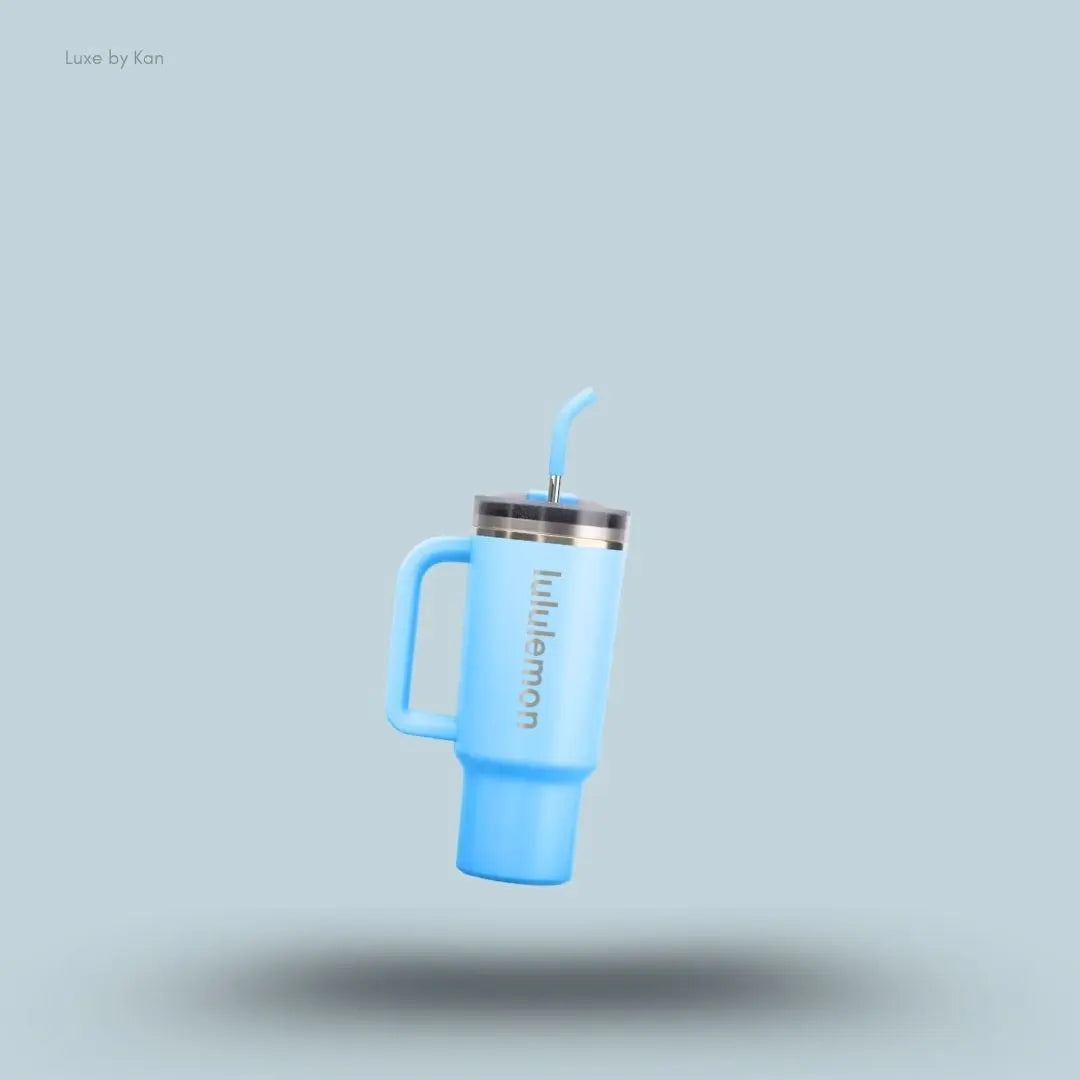 Lululemon Back to Life Tumbler 24oz in light blue with handle and straw lid, on light blue background
