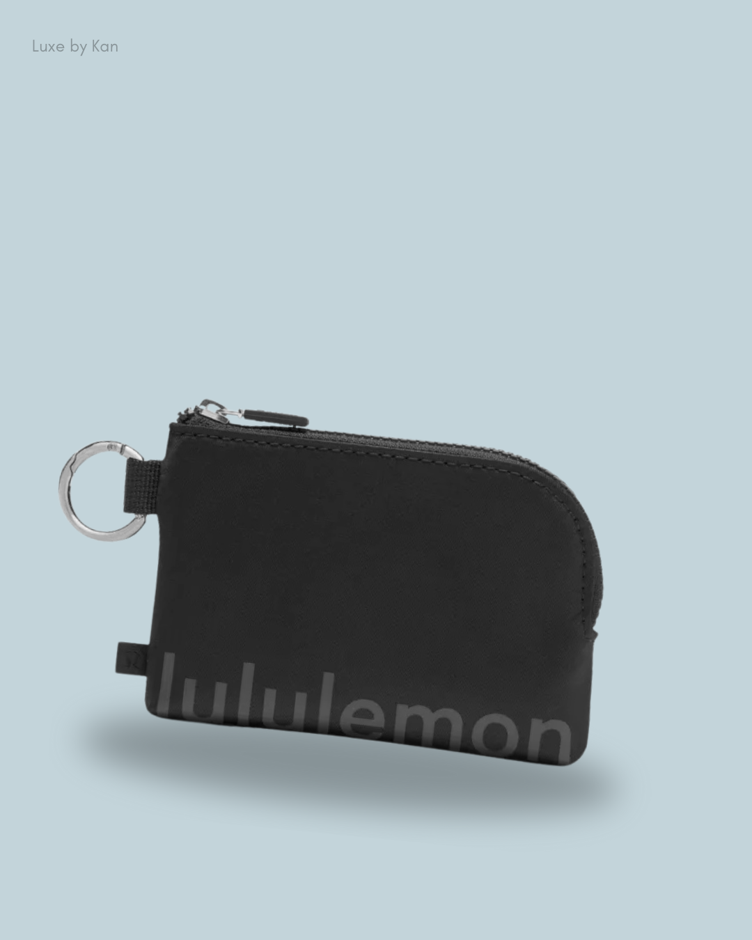 A black clippable card pouch with a keyring, featuring "Lululemon" branding.