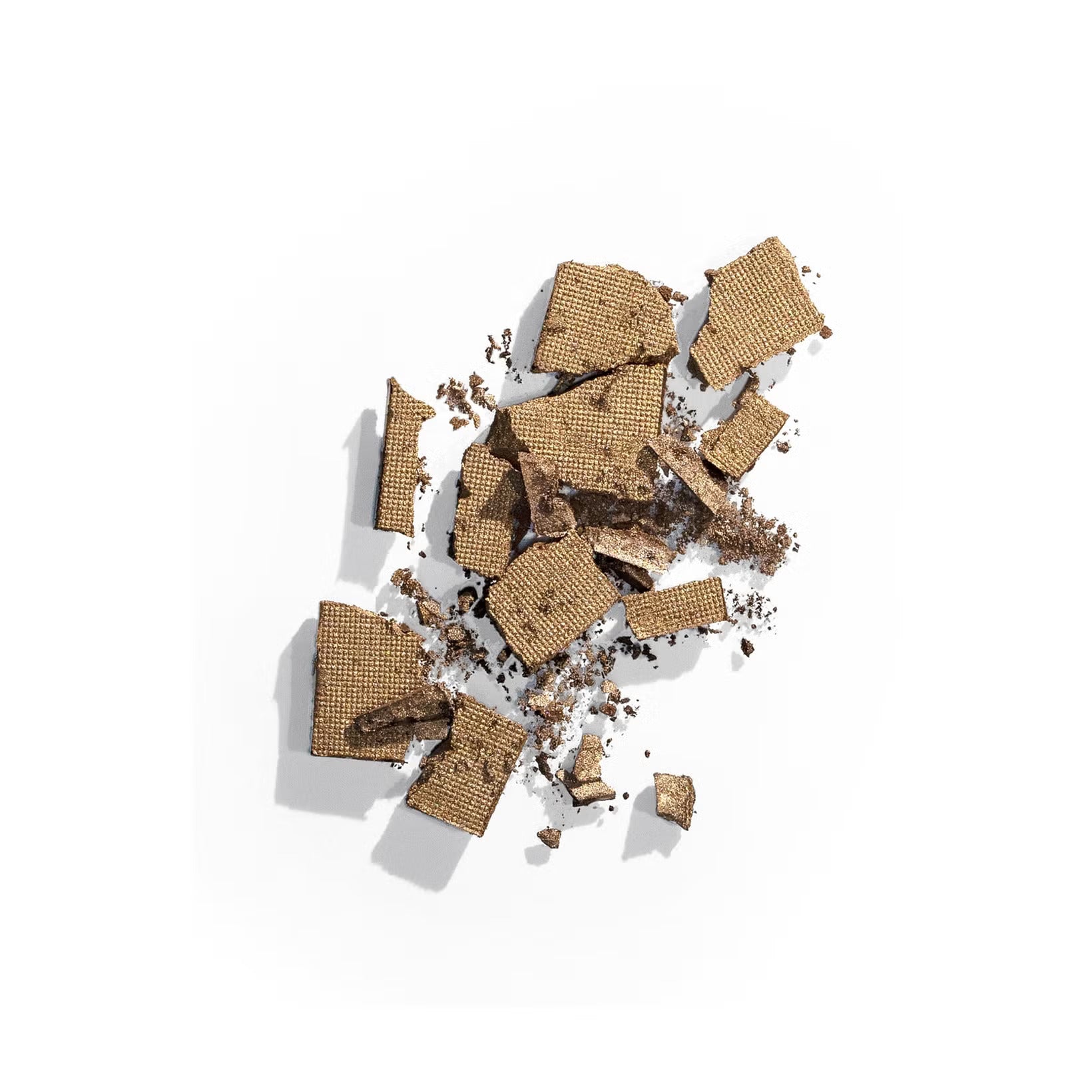 Color Wow crumbled chocolate wafer pieces scattered on a clean white background, highlighting their textured layers and crisp structure.