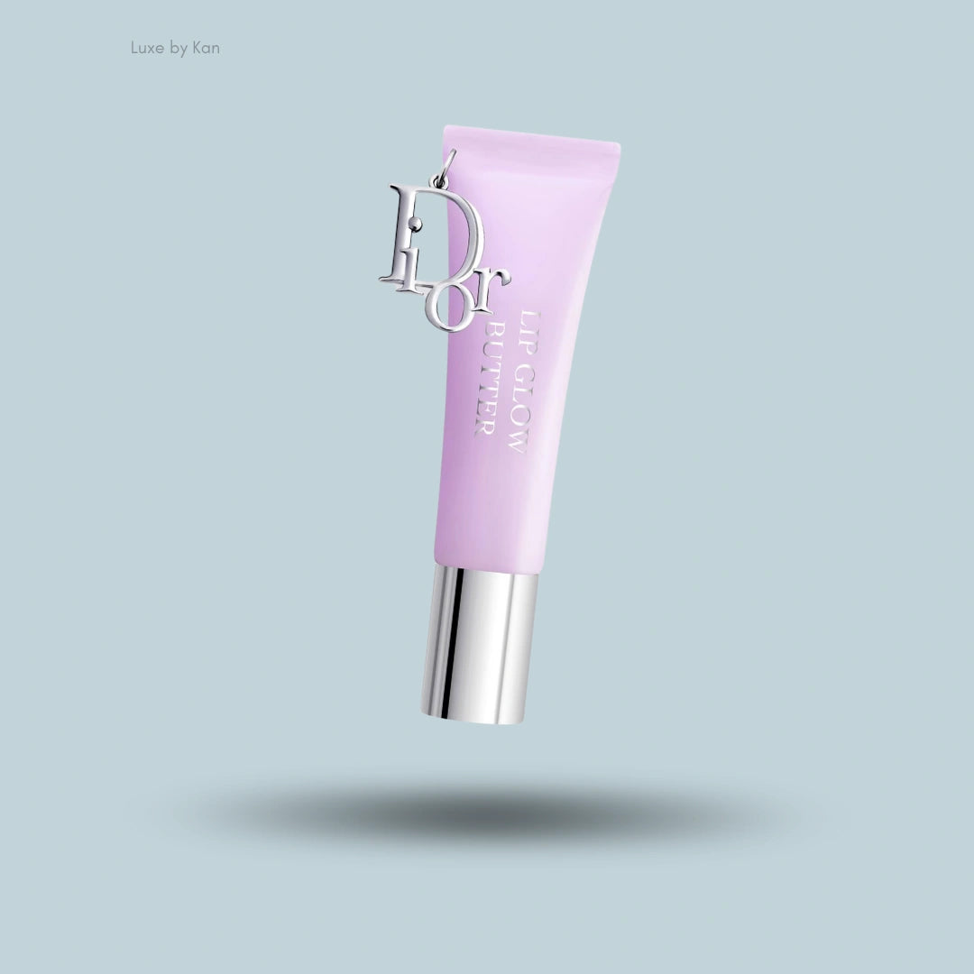 Dior Addict Lip Glow Butter tube in light purple with silver accents and "Dior" charm.