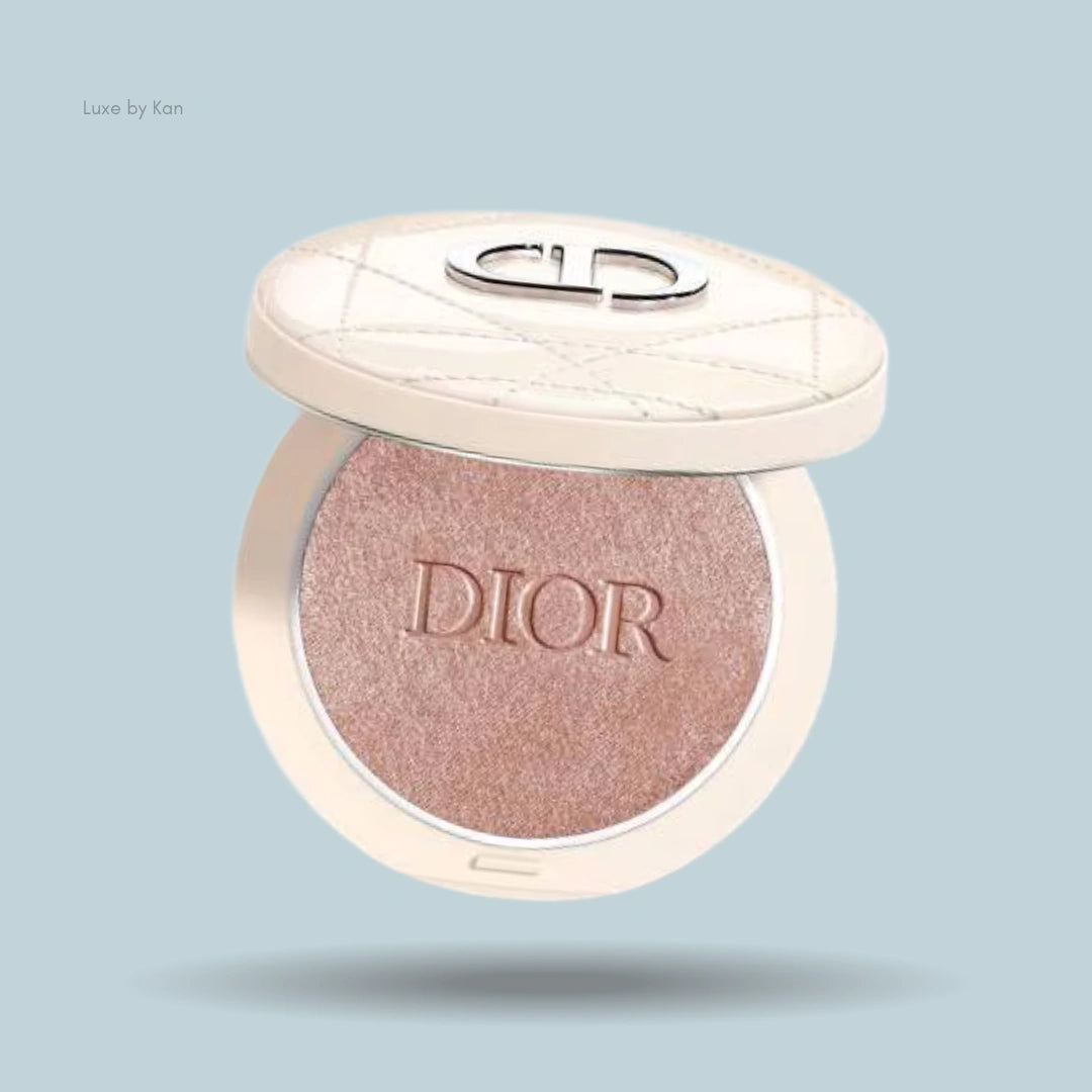 Dior Forever Couture Luminizer highlighting powder in a round, ivory compact, partially open, with a silver Dior logo on the lid.