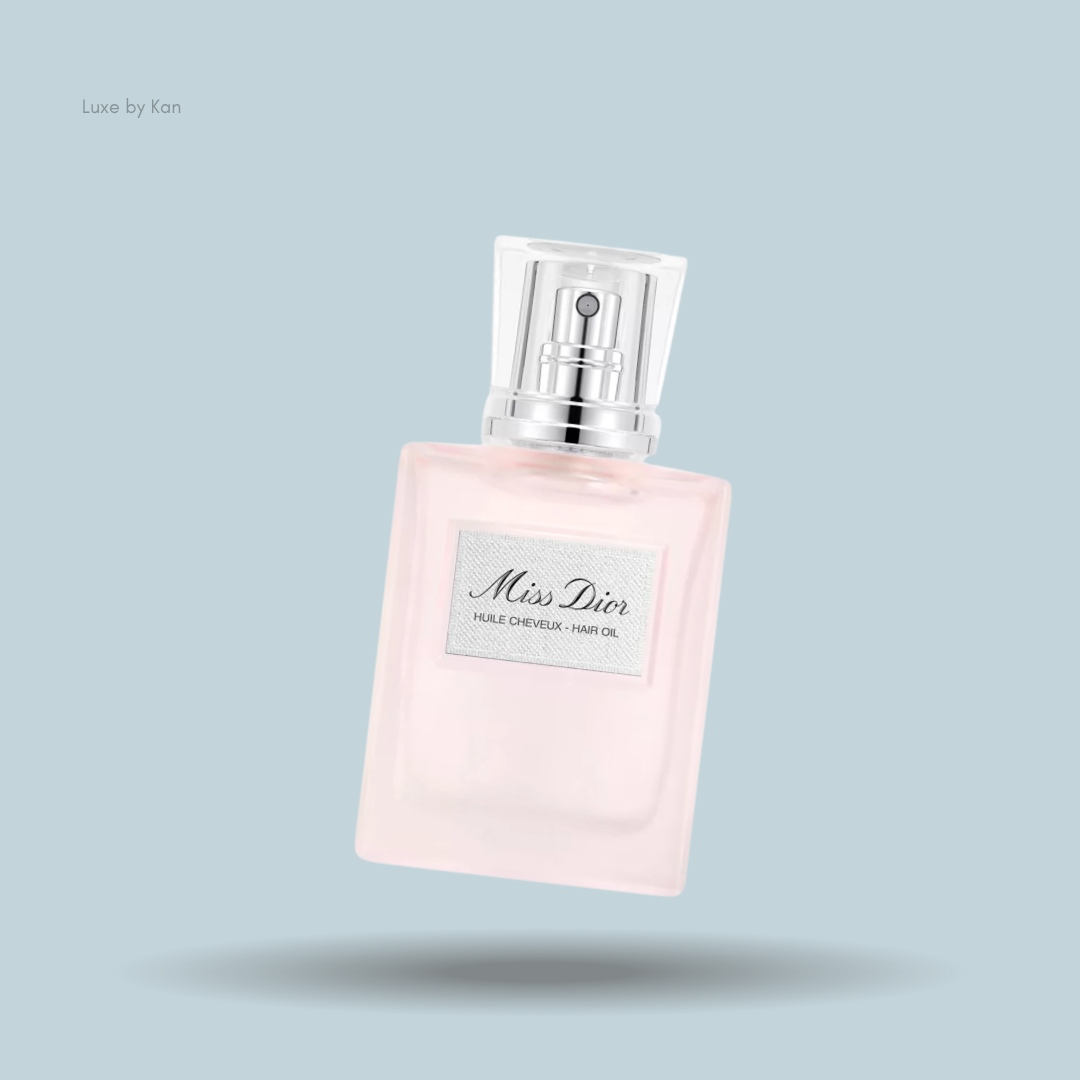 Miss Dior hair oil in a clear glass bottle with a silver collar and clear plastic cap.