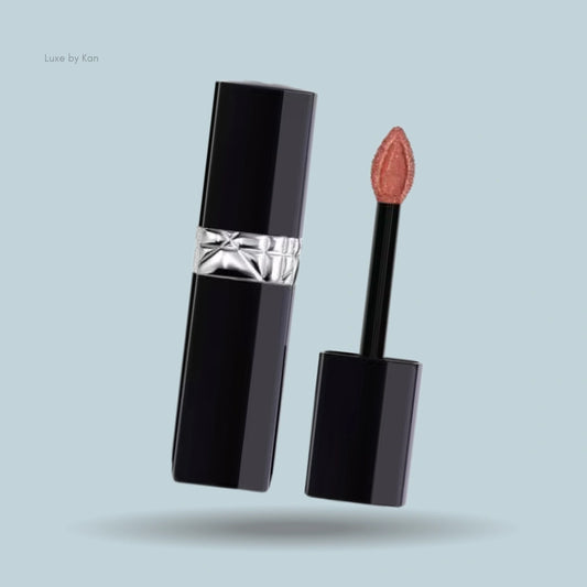 Dior Rouge Dior Forever liquid lipstick, black packaging with Dior logo detail, applicator wand rests alongside.