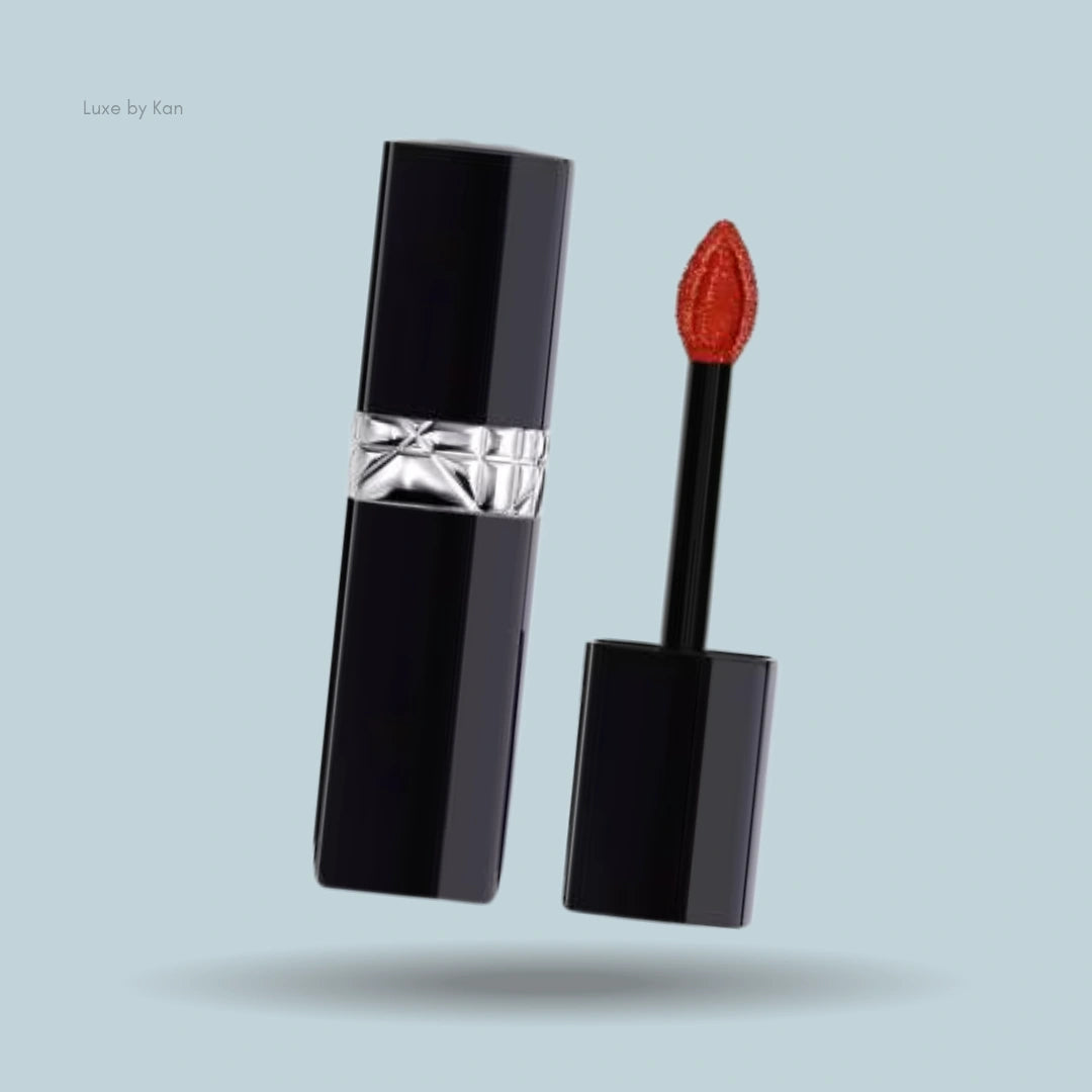 Opened Dior Rouge Dior Forever Lacquer in a sleek black case, featuring a petal-shaped orange applicator.