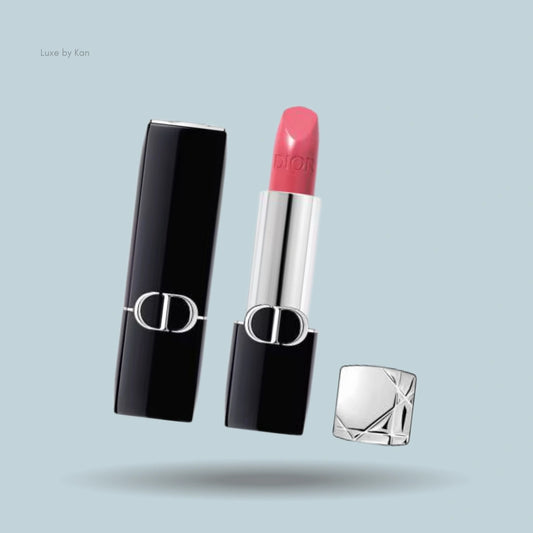 Open Dior Rouge lipstick with classic black casing, CD logo, pink velvet color, and silver top off to the side.