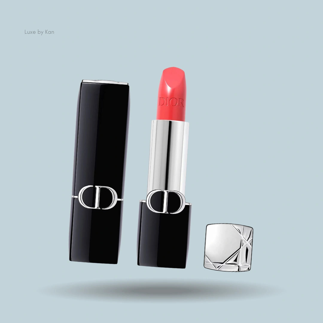 Dior rouge new velvet lipstick tube, black and silver packaging, coral shade.