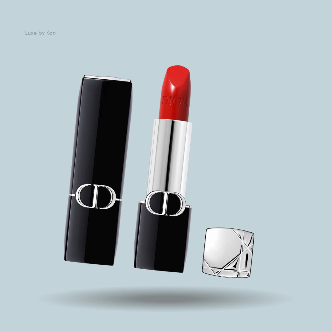 Dior Rouge New Velvet Lipstick, opened to reveal a classic red shade, housed in elegant black and silver packaging.
