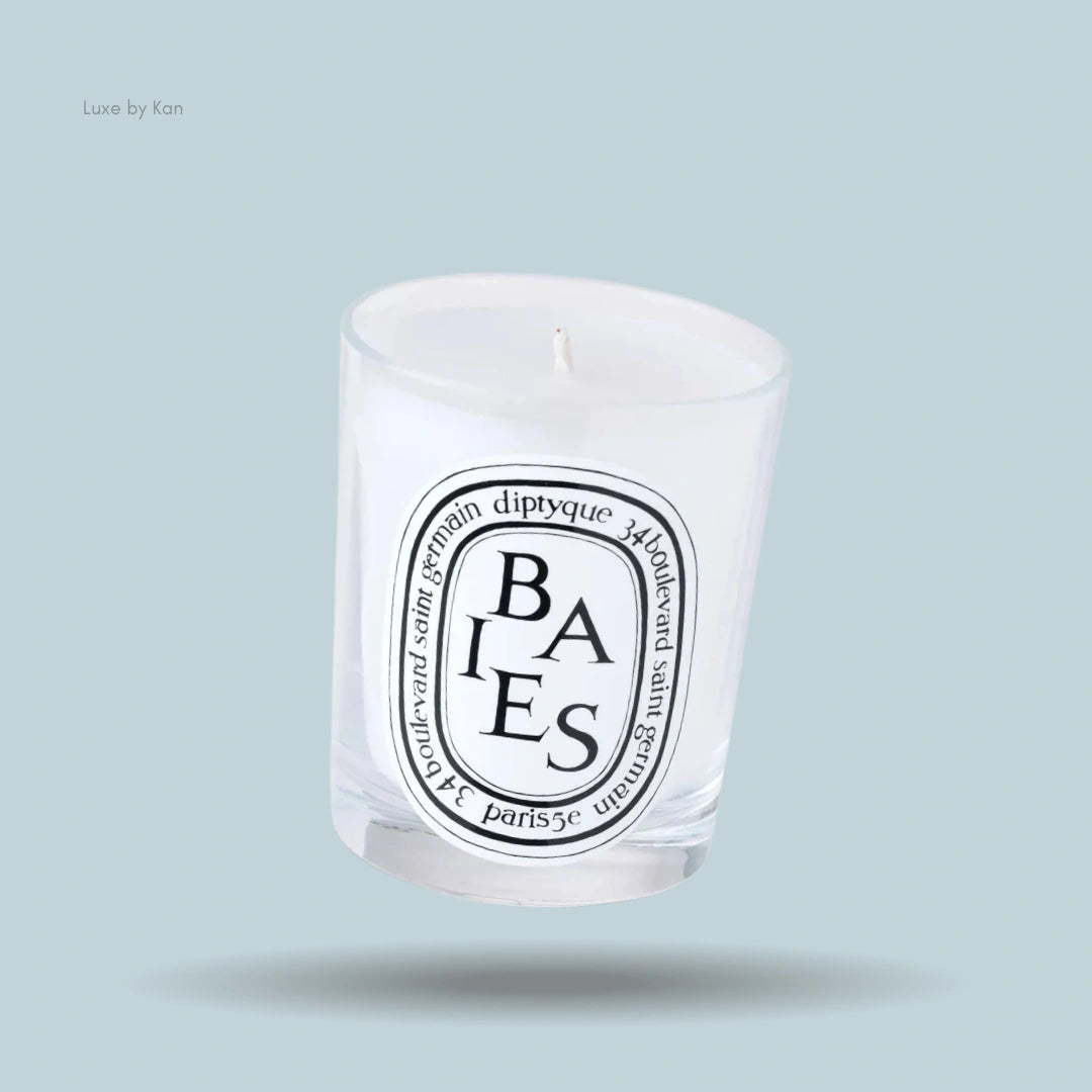 Diptyque Baies scented candle in a clear glass holder with a white label.