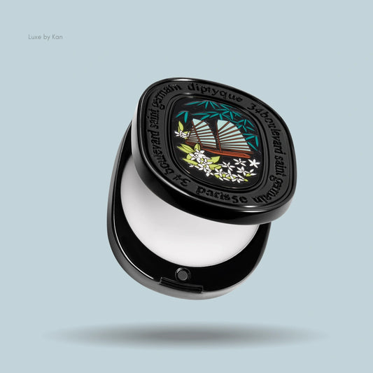 Diptyque Do Son solid perfume compact; case is black with a boat and flower graphic on top.