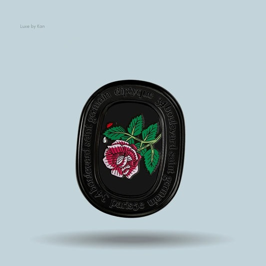 Diptyque eau rose solid perfume in a black case with a rose design.