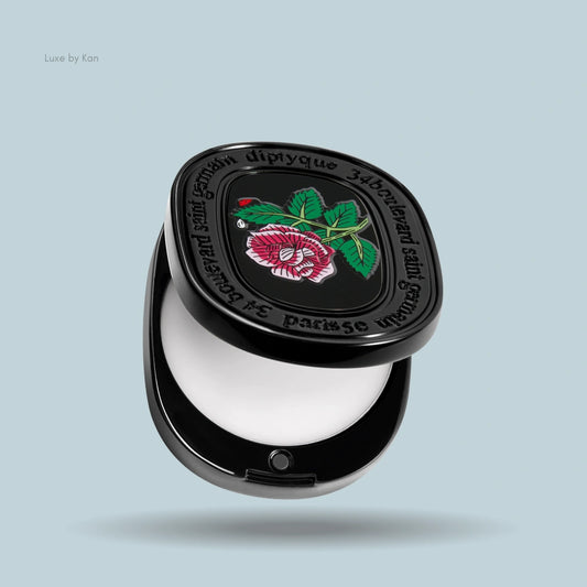 Diptyque Eau Rose solid perfume compact with open lid, revealing solid perfume inside and a rose design on the lid.