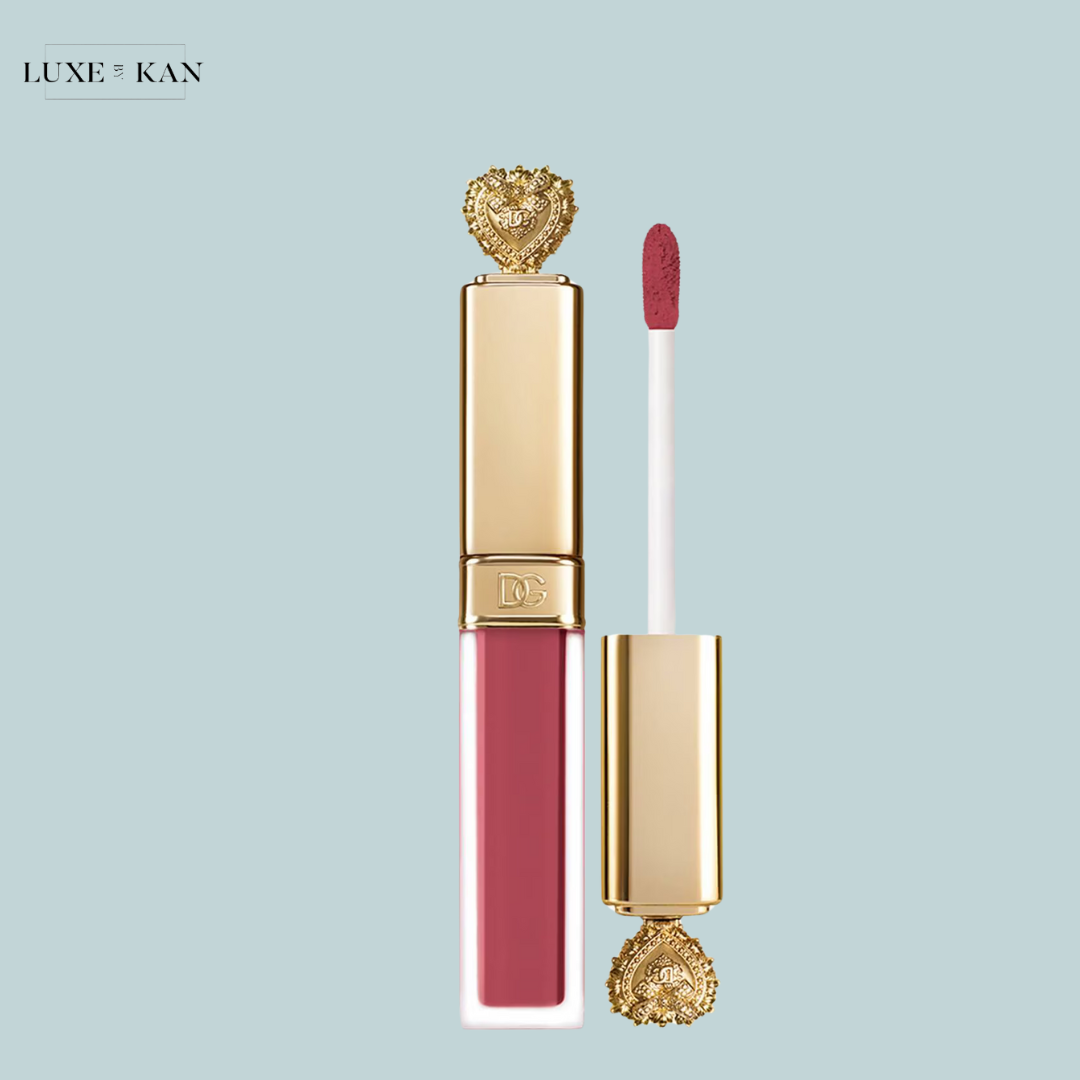 Dolce & gabbana everkiss liquid lip no transfer soft matte liquid lipstick in a luxurious gold tube topped with an ornate heart design, accompanied by a white applicator wand.
