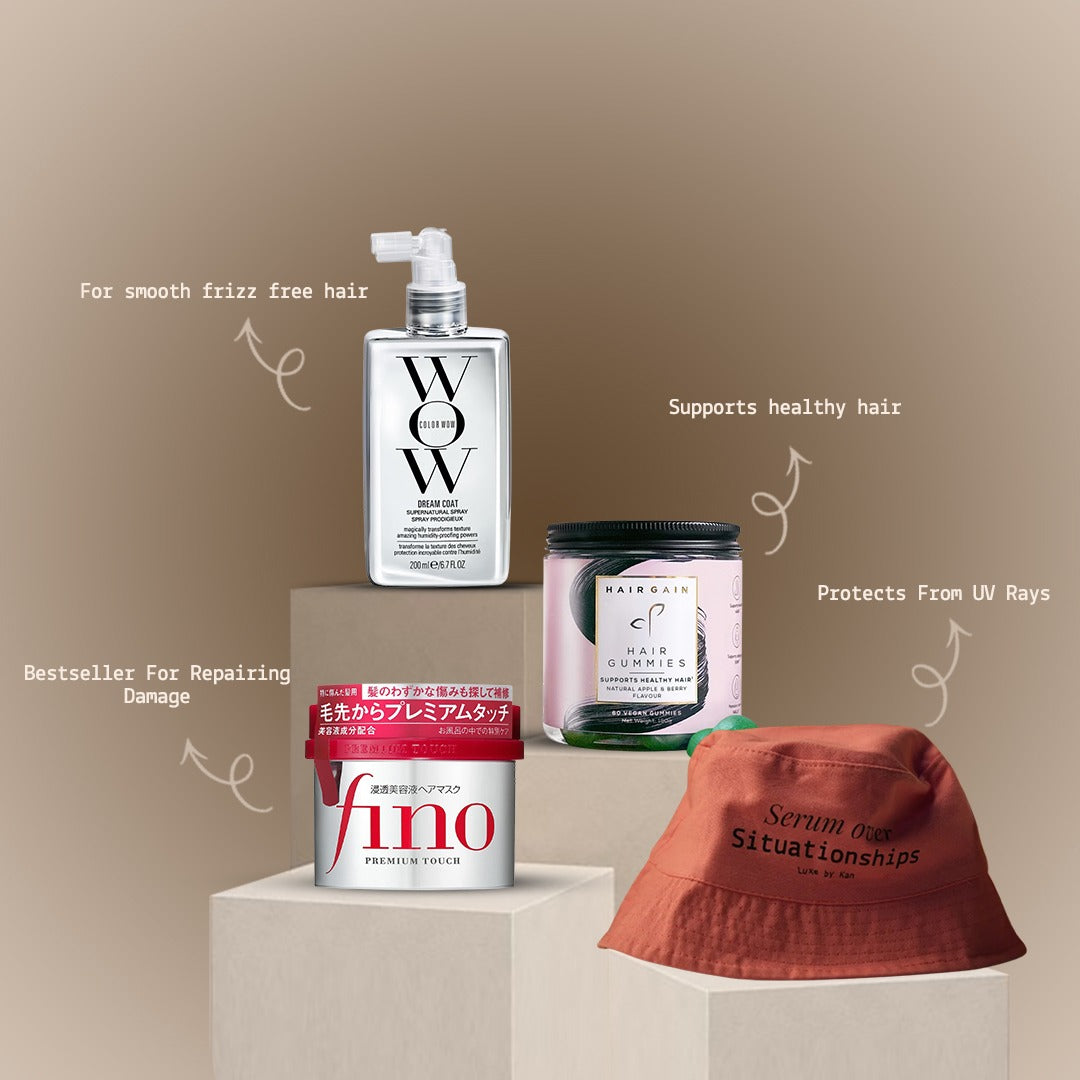 Hair care products like Wow spray and Fino mask displayed on pedestals with a bucket hat on a soft brown background.