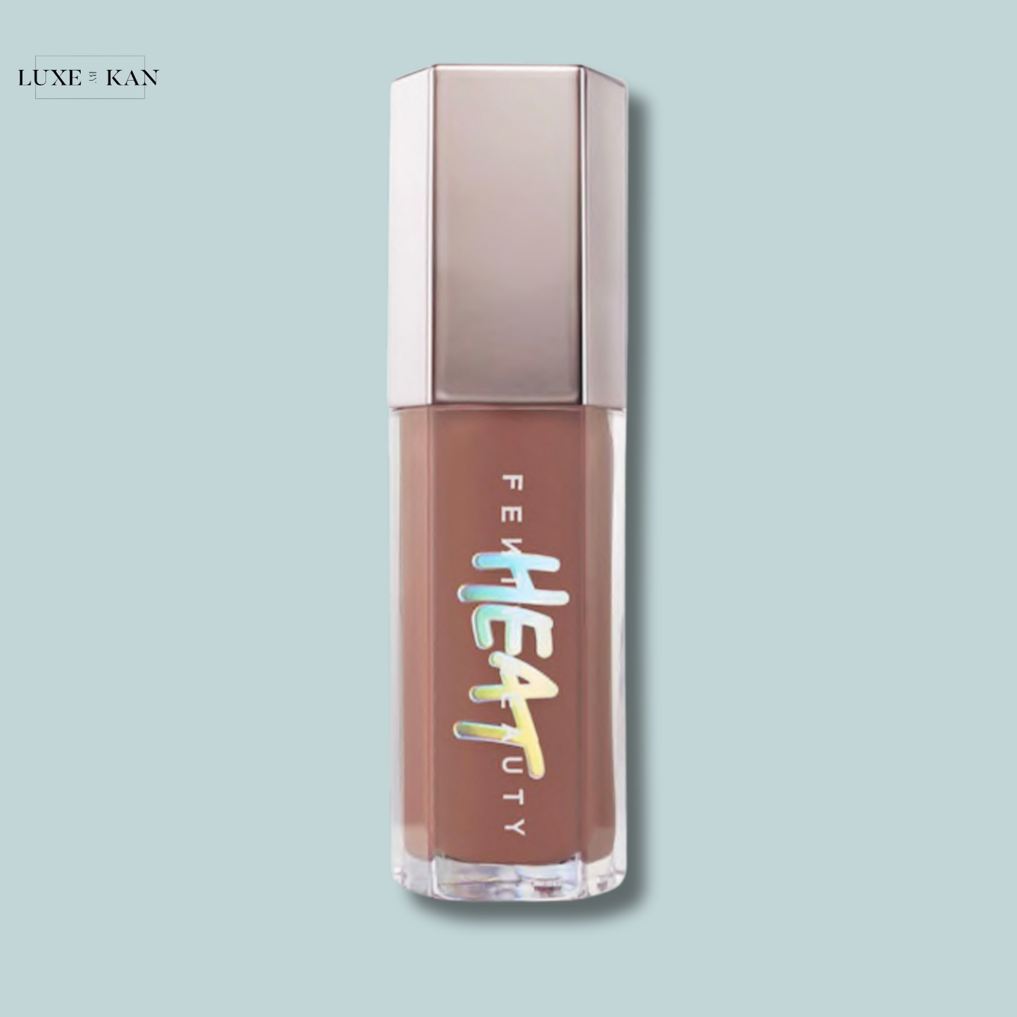Fenty Beauty Gloss Bomb Heat lip gloss with a taupe cap and clear packaging on a light blue background.
