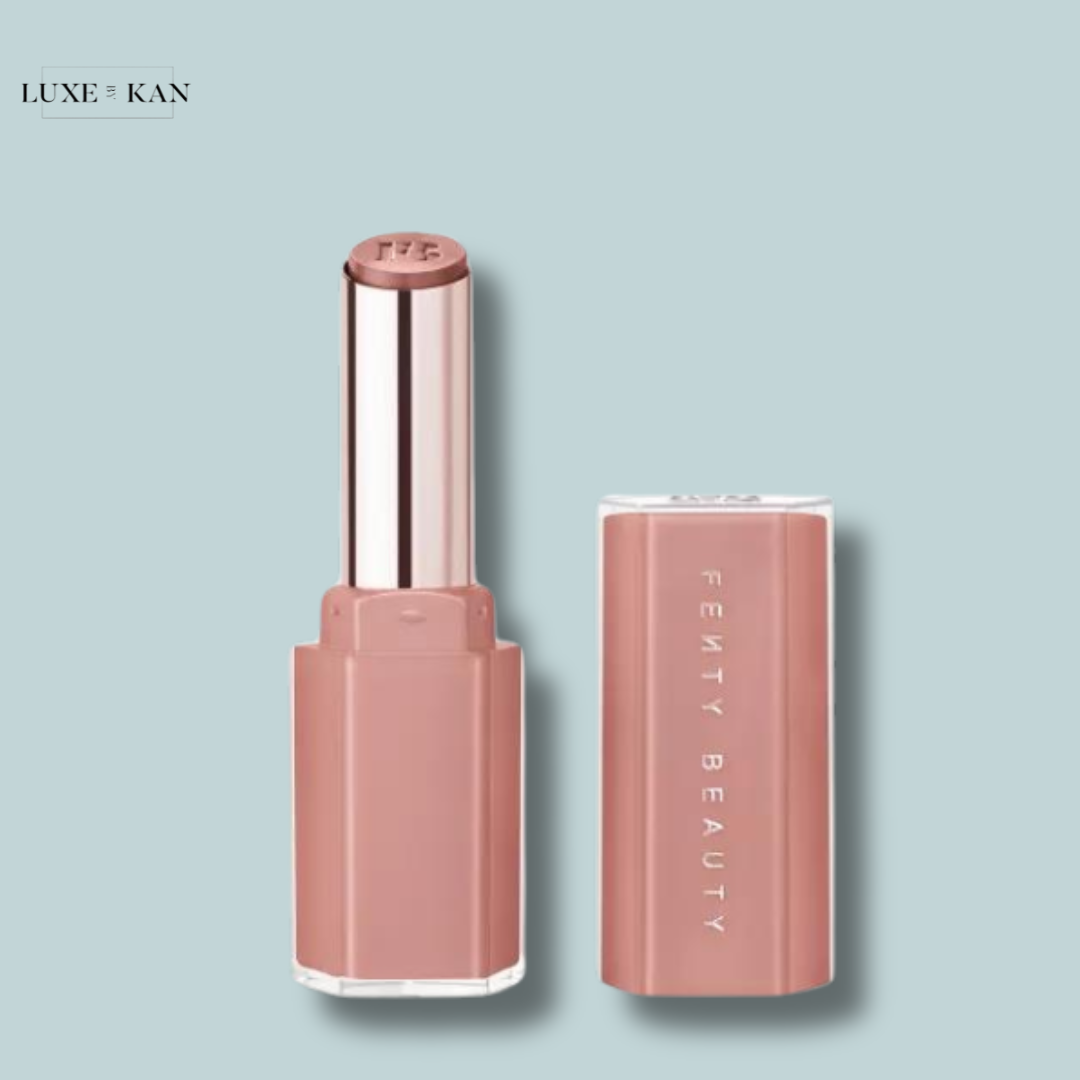 Fenty Beauty Gloss Bomb Stix Lip Gloss with its lid removed, revealing a mauve-colored balm.