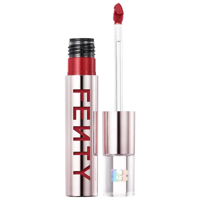 Fenty Beauty Icon Velvet Lipstick in a sleek silver tube, featuring a red logo and an applicator wand with red lip color on the tip.