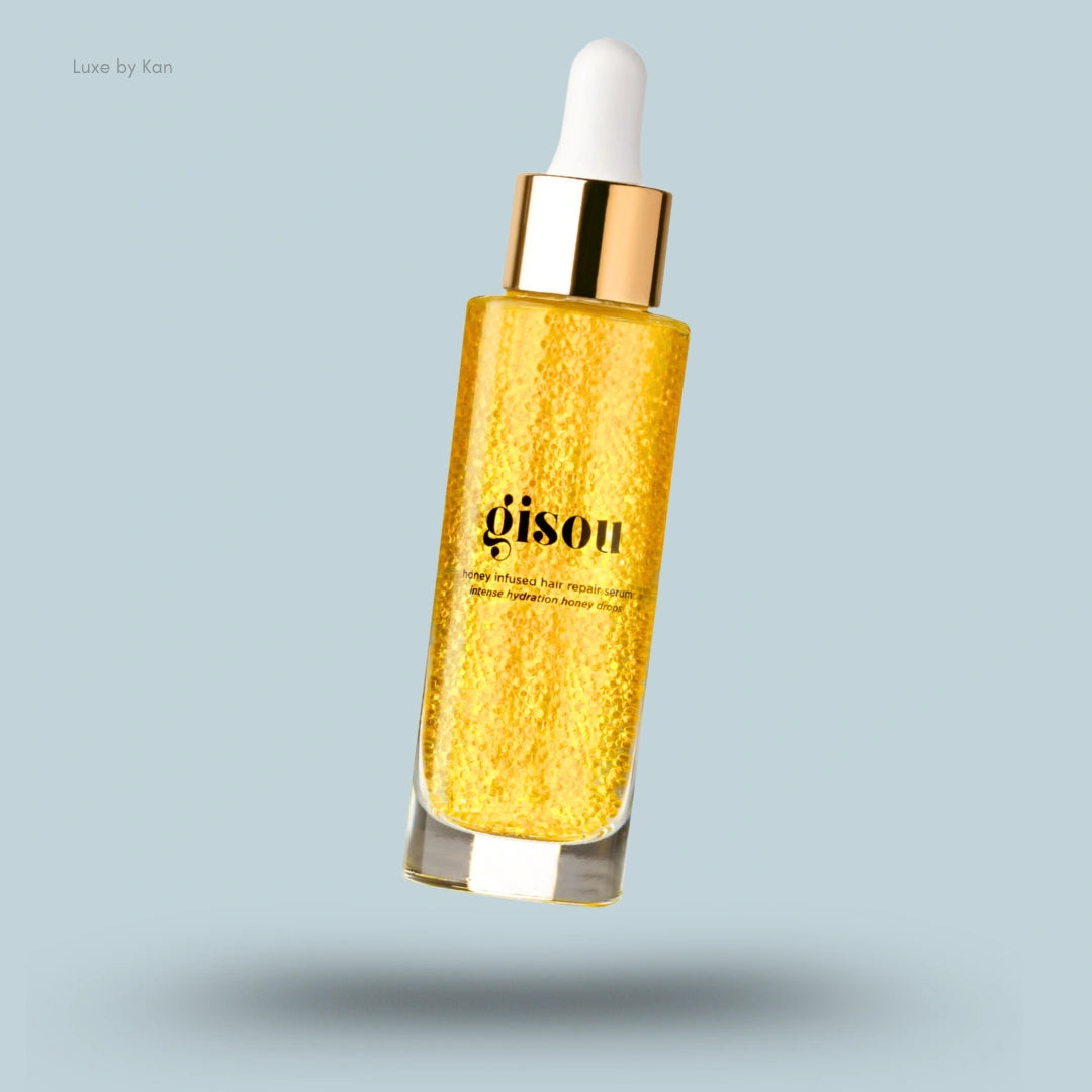 Gisou honey-infused hair repair serum with golden liquid in a sleek bottle.