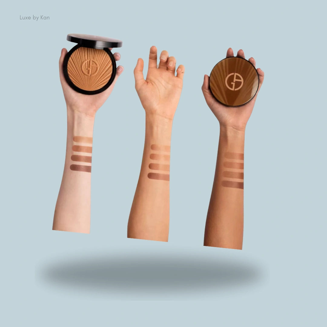 Armani luminous silk summer glow bronzer swatches displayed on three different skin tones, with the compact held beside each swatch for reference.