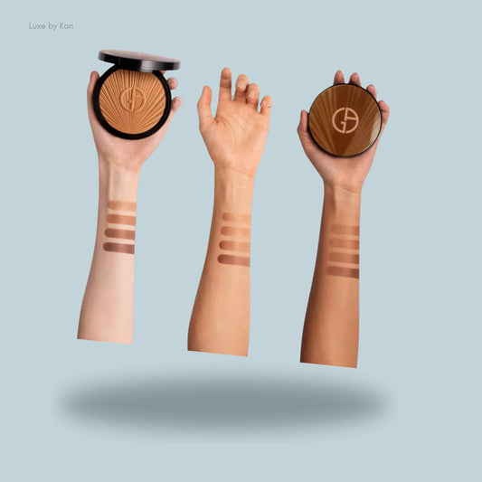 Armani luminous silk summer glow bronzer swatches displayed on three different skin tones, with the compact held beside each swatch for reference.