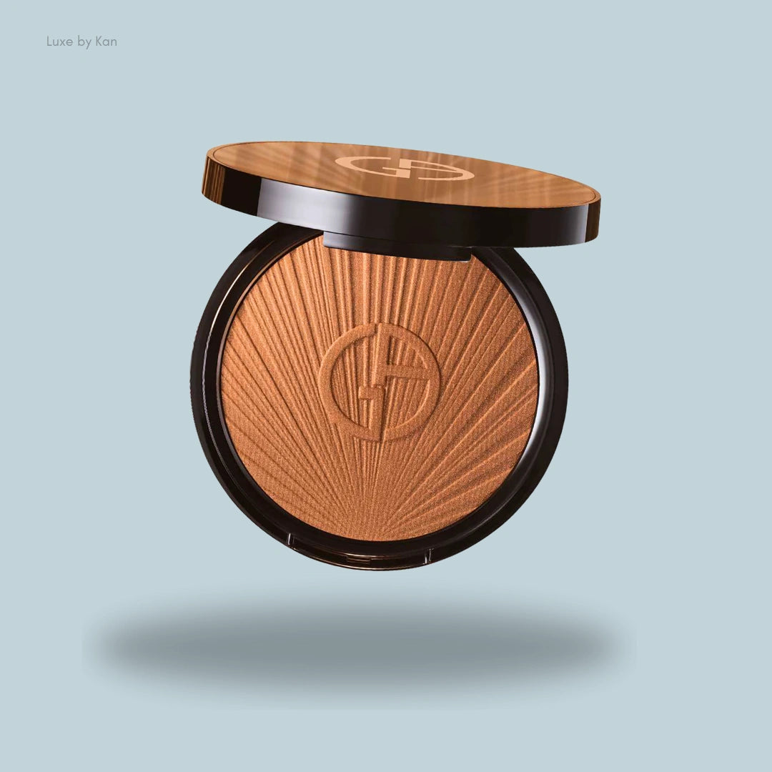 A luminous silk summer glow bronzer compact with a sunburst design, featuring the Giorgio Armani logo.