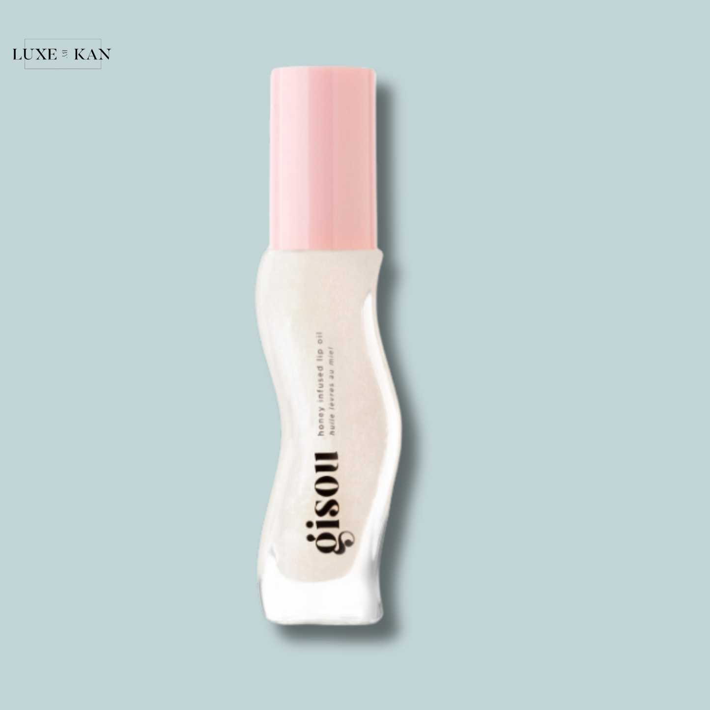 Gisou honey-infused hair oil with a pink cap.