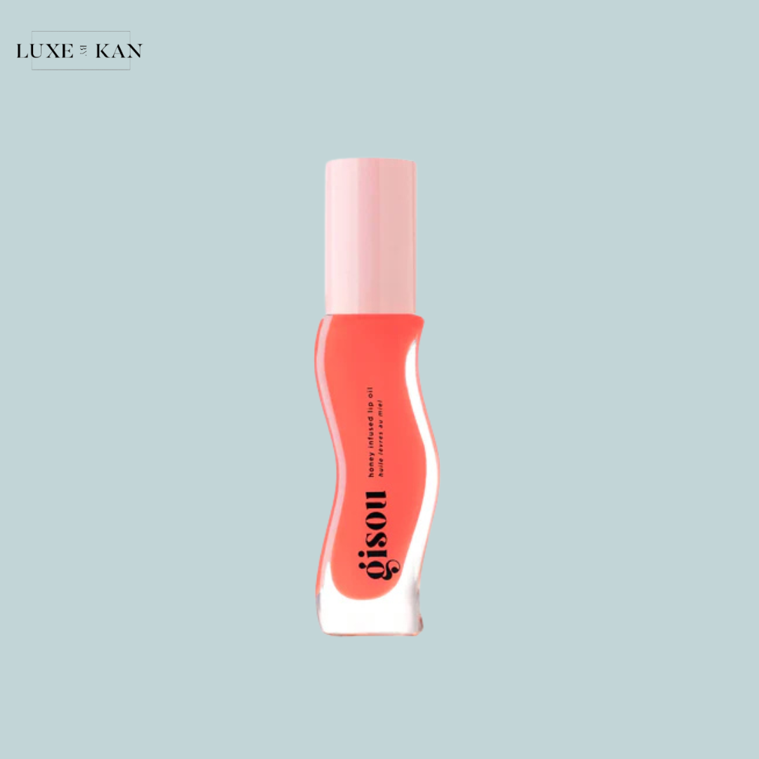 GISOU honey-infused hair oil, featuring a curved design and a light pink cap.