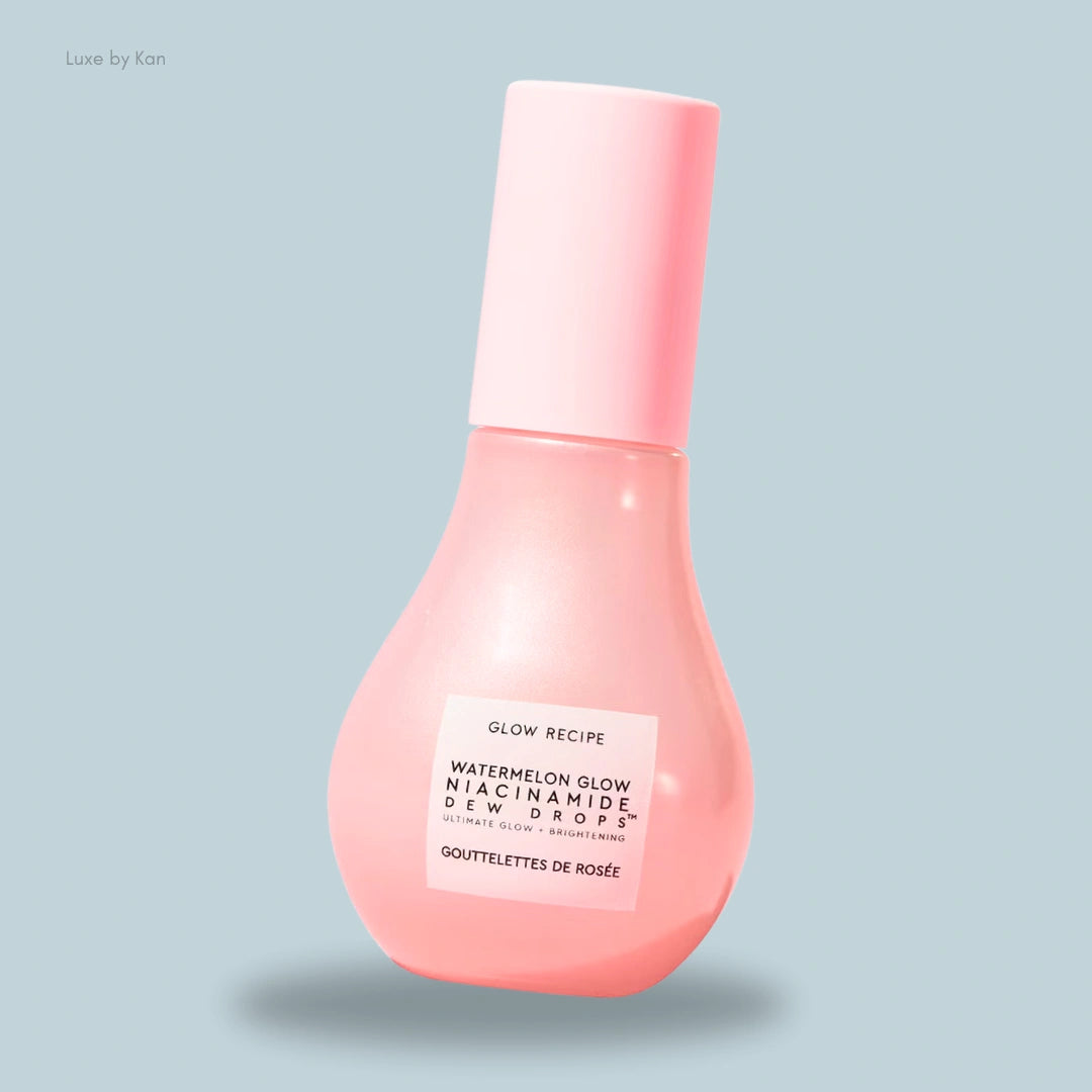 A pink teardrop bottle of Glow Recipe Watermelon Glow Niacinamide Dew Drops floats against a soft, light blue background.