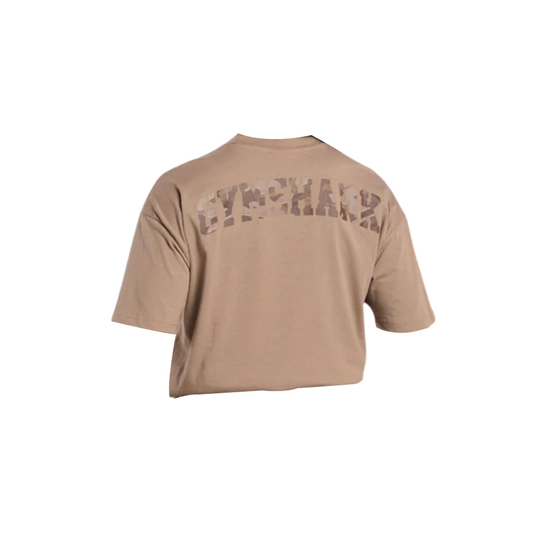 Beige unisex t-shirt with "GYMSHARK" printed in a subtle camo design across the back. Short sleeves and a relaxed fit.