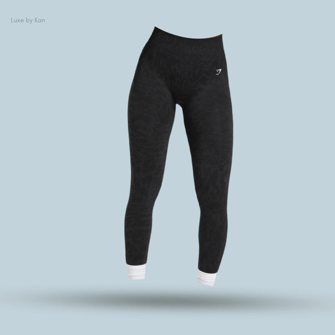 Black Adapt Safari Seamless Leggings featuring a subtle textured design and white striped cuffs.