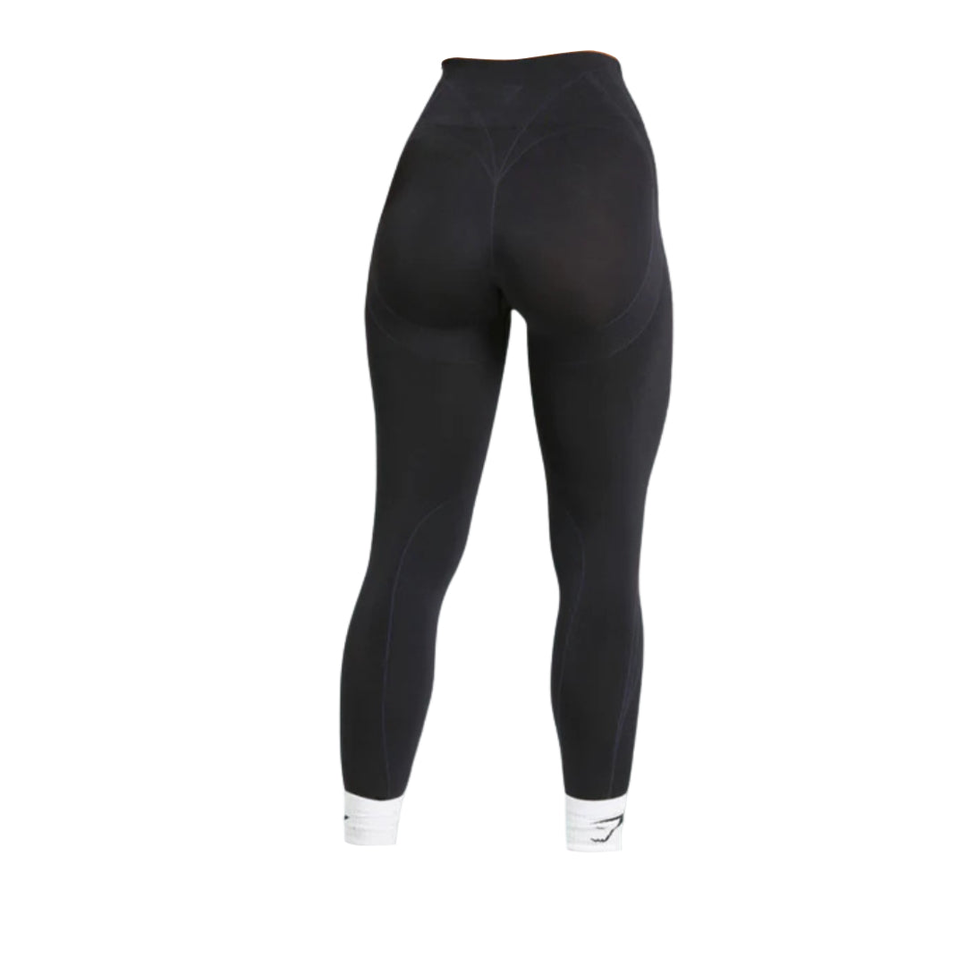 Black leggings with high waist, featuring subtle seam details and fitted design, shown from the back.