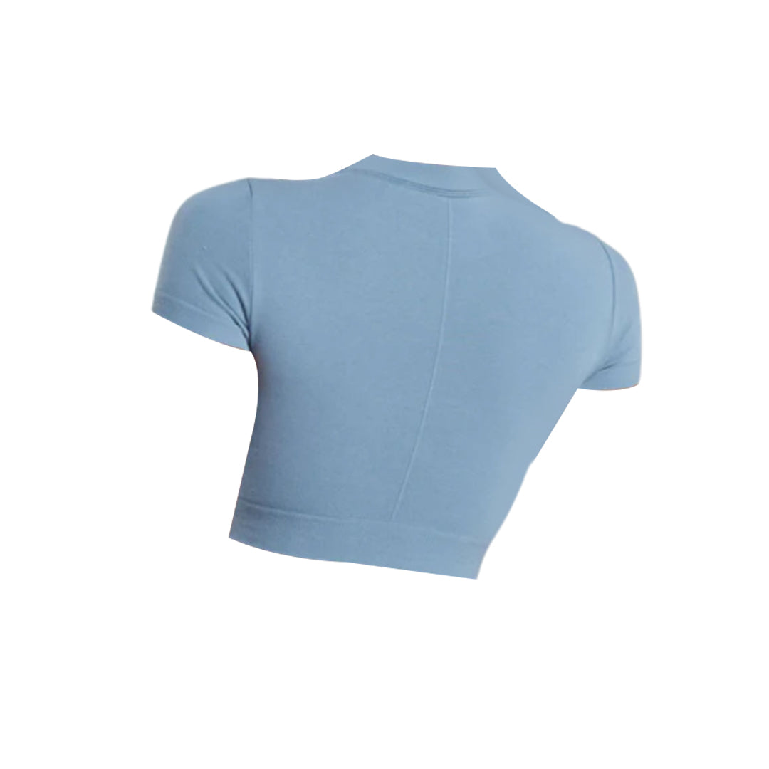 Back view of Gymshark cotton seamless crop top in light blue, featuring short sleeves, stretch fit, and contour stitching.