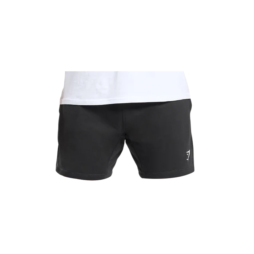 Close-up of Gymshark men's crest shorts in black with a white logo on the right leg and a white t-shirt above the shorts.