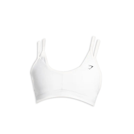 White sports bra with adjustable double straps and a small logo on the left side, ideal for active wear and workouts.