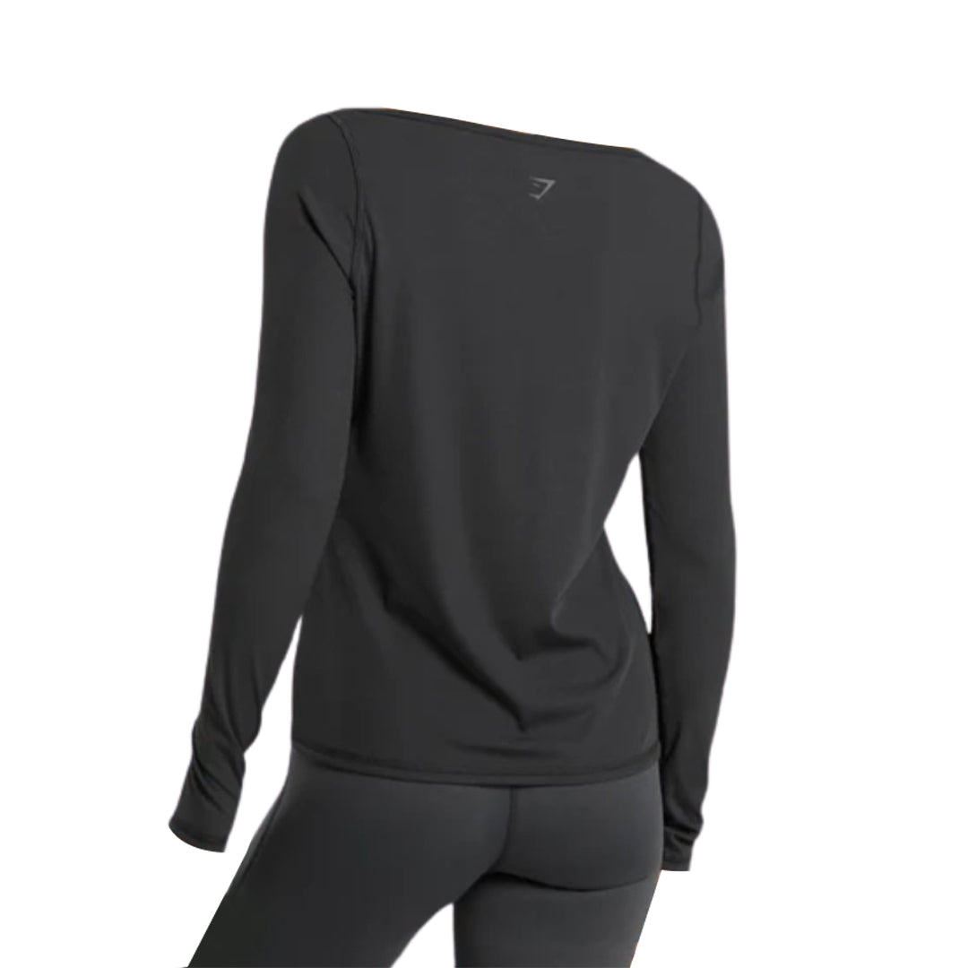 A stylish black Gymshark Elevate Long Sleeve Top, viewed from the back and paired with matching leggings.