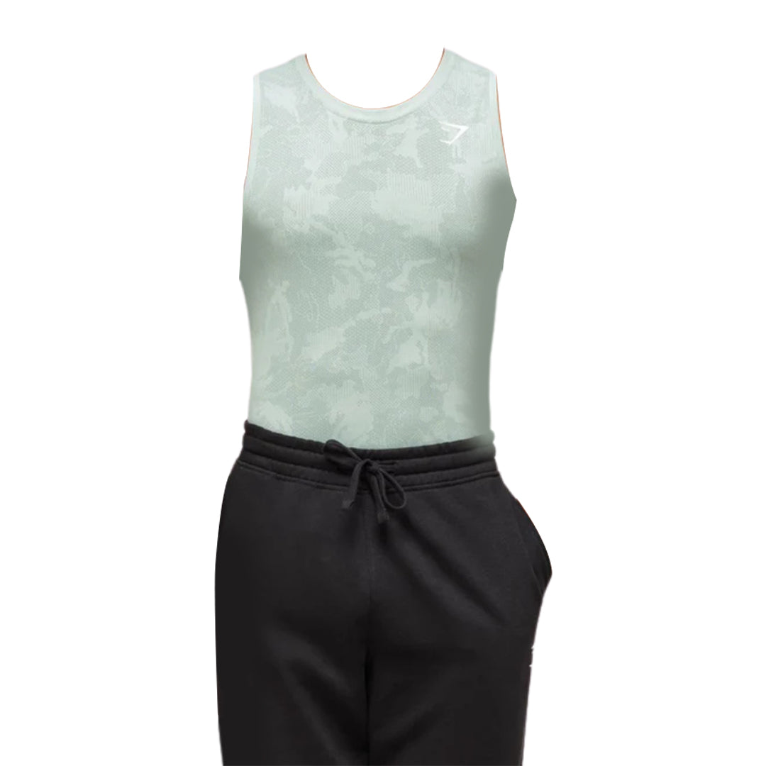 Men’s light green Geo Seamless tank top in a slim fit, paired with black drawstring joggers, styled for fitness and comfort.
