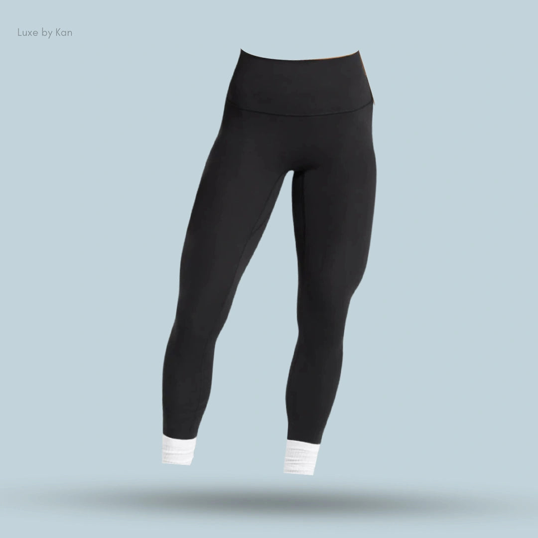 Black Gymshark high-waisted leggings with a sleek fit and white ankle cuffs.