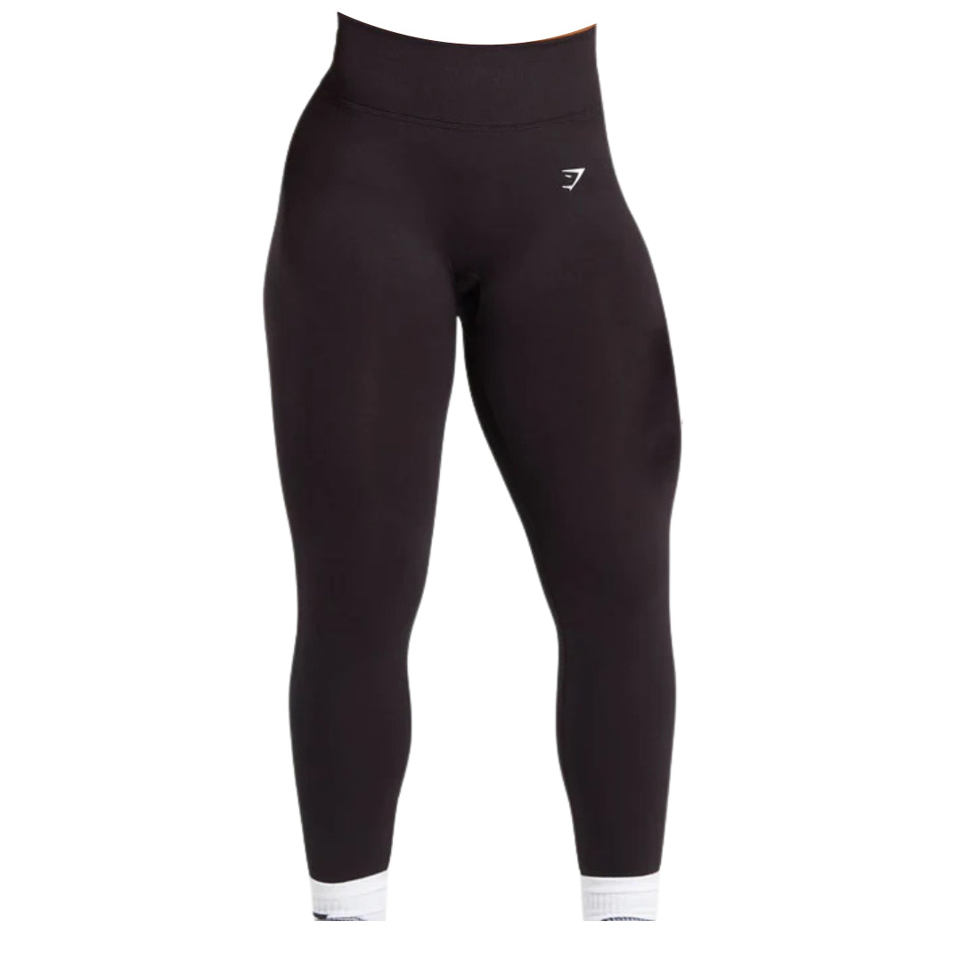 Black high-waisted leggings with a fitted silhouette and white ankle detailing, featuring a small logo on the waistband.